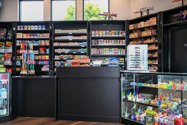 Front counter and back wall stocked with rolling papers, glass and smoking accessories