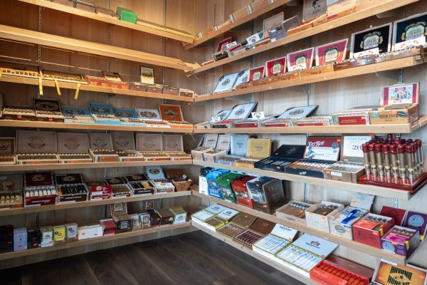 Interior of a walk-in cigar humidor stocked with premium cigars
